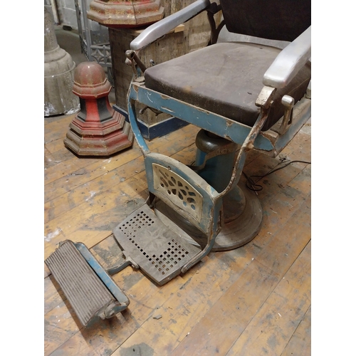 618 - Early 20th C. cast iron and upholstered vinyl barbers chair{105 cm H x 60 cm W x 100 cm D}.