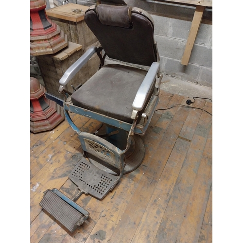 618 - Early 20th C. cast iron and upholstered vinyl barbers chair{105 cm H x 60 cm W x 100 cm D}.