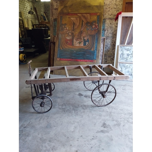 656 - Early 20th C. pine coffin cart on wrought iron stand and wheels {68 cm H x 184 cm W x 76 cm D}.