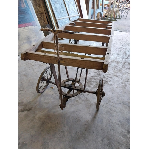 656 - Early 20th C. pine coffin cart on wrought iron stand and wheels {68 cm H x 184 cm W x 76 cm D}.