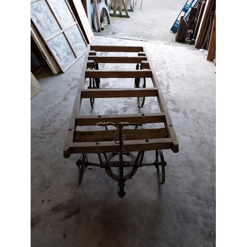 656 - Early 20th C. pine coffin cart on wrought iron stand and wheels {68 cm H x 184 cm W x 76 cm D}.