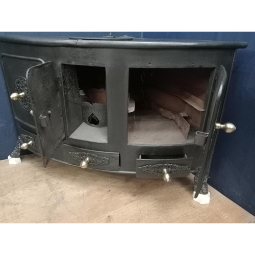 169 - Cast iron corner stove with brass knobs and aluminium feet {H 77cm x W 130cm x D 86cm }.