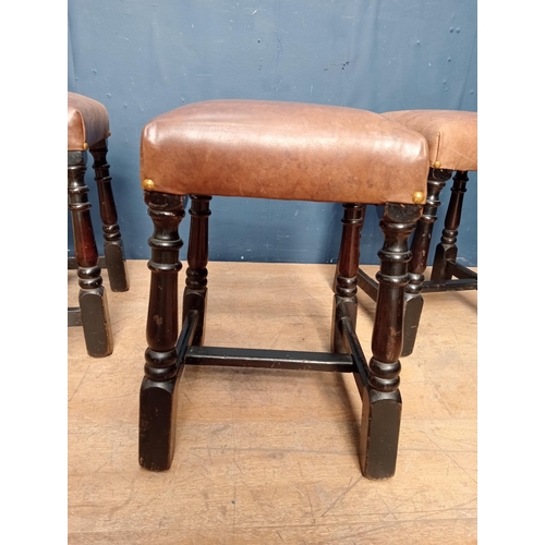 645 - Three brown leather low stools {H 47cm x W 36cm x D 36cm }.