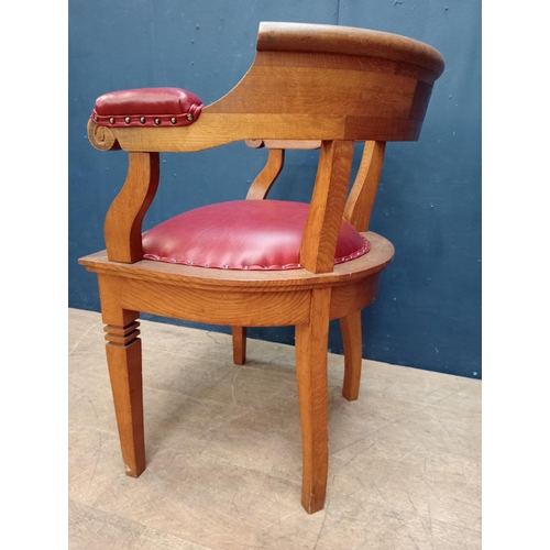 86 - Oak desk chair with red leather upholstered seat and arms {H 75cm x W 58cm x D 52cm }.