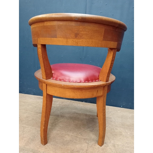 86 - Oak desk chair with red leather upholstered seat and arms {H 75cm x W 58cm x D 52cm }.