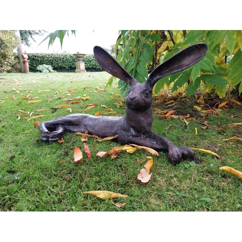 72 - Exceptional quality bronze sculpture of a hare lying down { 32cm H x  61cm W x 24cm D}