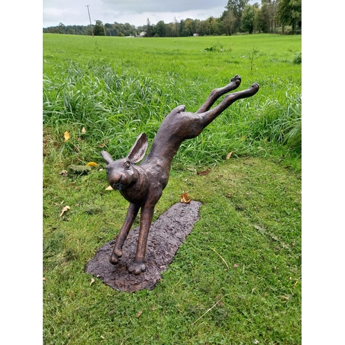 90 - Exceptional quality bronze sculpture of a leaping hare {58cm H x 88cm W x 37cm D}