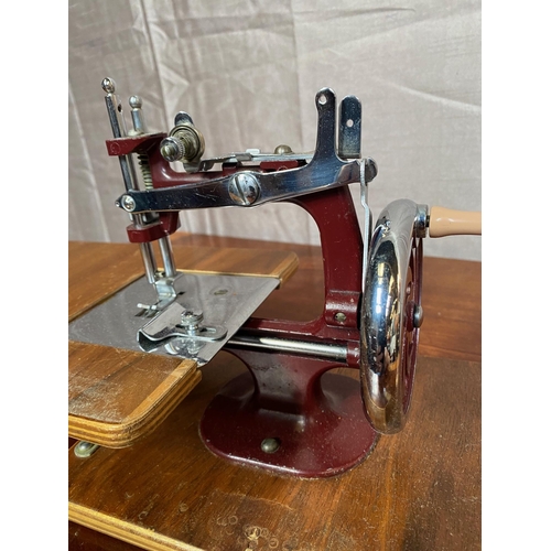 148A - Small cased sewing machine in working order.