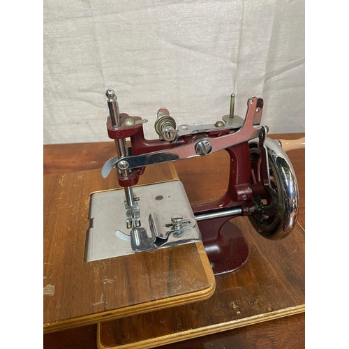 148A - Small cased sewing machine in working order.