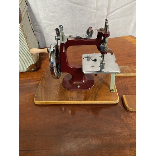 148A - Small cased sewing machine in working order.