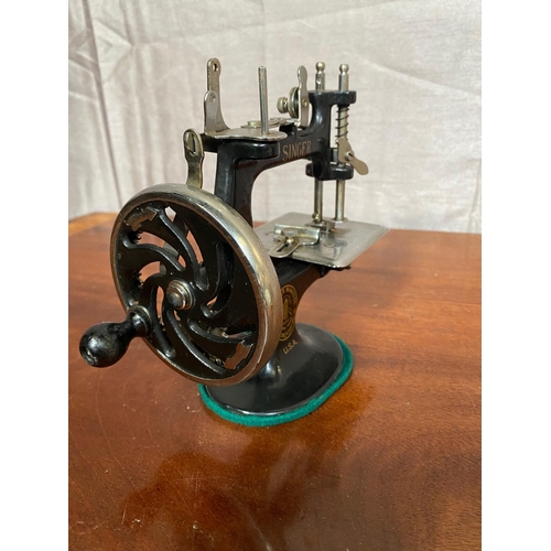 157A - Unusual small cast iron Singer sewing machine.