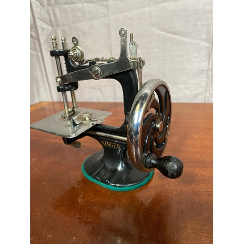 157A - Unusual small cast iron Singer sewing machine.