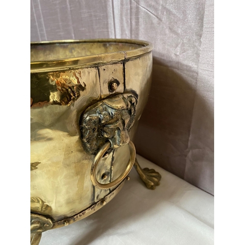 169A - Decorative brass log bucket raised on claw feet. {30 cm H x 47 cm W x 37 cm D}.