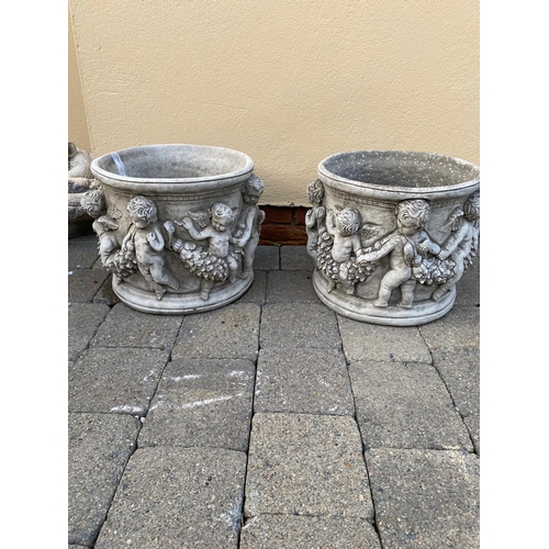 249A - Pair of circular stone planters decorated with cherubs. {32 cm H x 36 cm Dia.}.