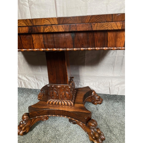 343A - Rosewood card table with square column on four carved outswept lion's paw feet. {73 cm H x 90 cm W x... 