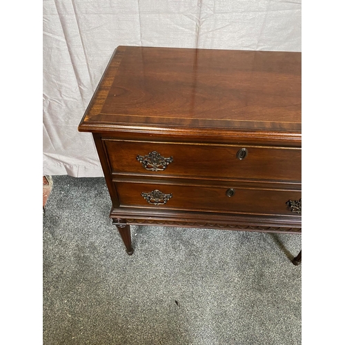 388A - Mahogany crossbanded chest of drawers with two drawers with metal mounts on four tapered legs. {81 c... 