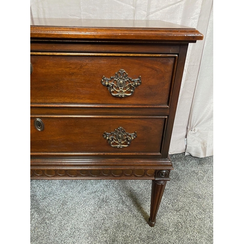 388A - Mahogany crossbanded chest of drawers with two drawers with metal mounts on four tapered legs. {81 c... 