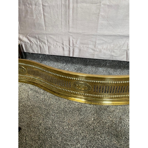 405A - Pierced brass serpentine fire fender. {129 cm W x 32 cm D}.