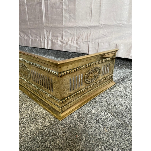 405A - Pierced brass serpentine fire fender. {129 cm W x 32 cm D}.