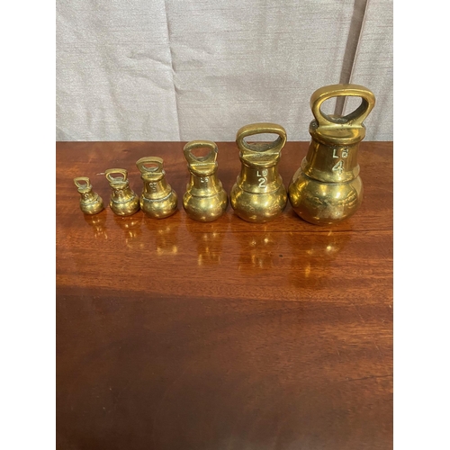 573A - Set of six graduated brass weights.