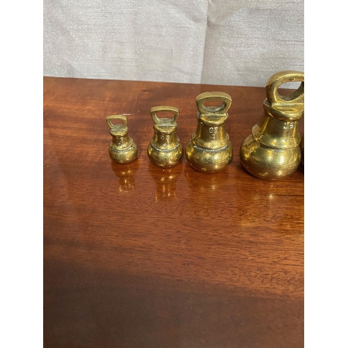 573A - Set of six graduated brass weights.