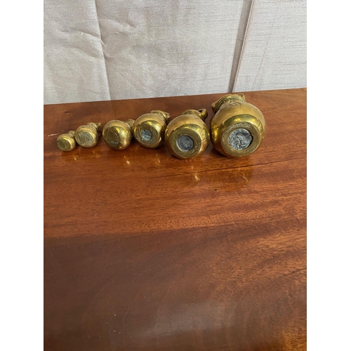 573A - Set of six graduated brass weights.