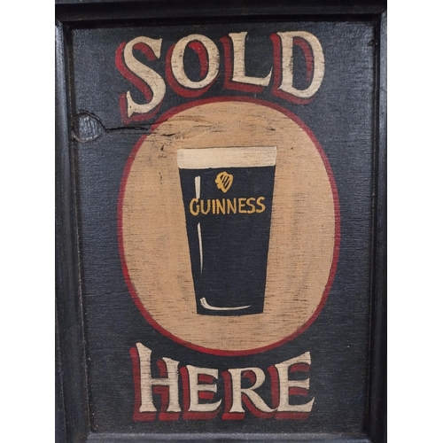 19 - Guinness Sold Here framed wooden advertising board. {37 cm H x 28 cm W}.