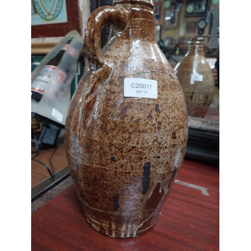 40 - 19th C. glazed stoneware flagon with damage. {24 cm H x 17 cm Dia.}.