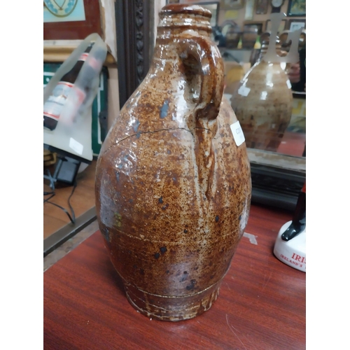 40 - 19th C. glazed stoneware flagon with damage. {24 cm H x 17 cm Dia.}.