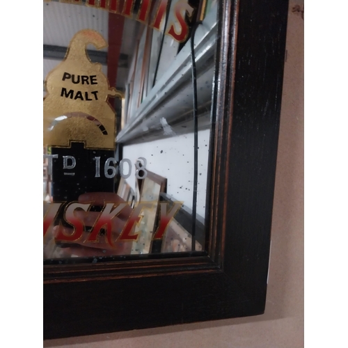 77 - Framed Bushmills Irish Whiskey advertising mirror. {34 cm H x 39 cm W}.