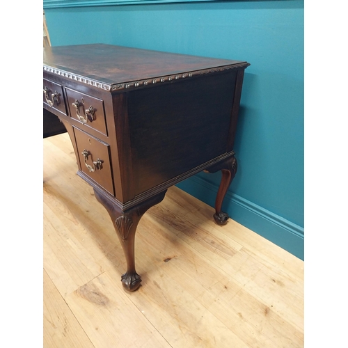 137 - Edwardian mahogany desk with inset leather top and brass handles raised on cabriole legs and ball an... 