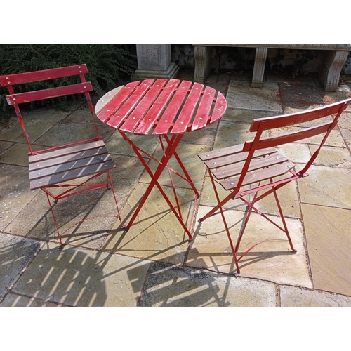 246 - Wood and metal three piece Bistro set. {Table : H 72cm x Dia 69cm Chair : H81cm x W41cm x D35cm}.