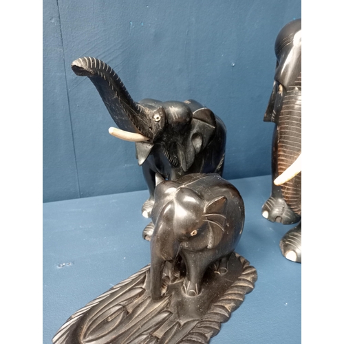 278 - Figural group of wooden elephants. {H 22cm down to H 10cm }.