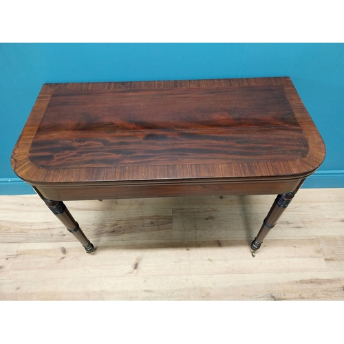 347 - Georgian mahogany and rosewood turn over leaf card table raised on turned legs and brass castors {73... 