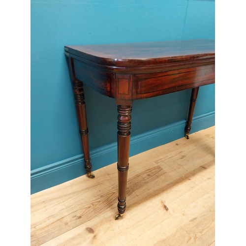 347 - Georgian mahogany and rosewood turn over leaf card table raised on turned legs and brass castors {73... 