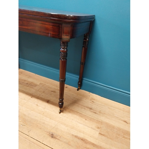 347 - Georgian mahogany and rosewood turn over leaf card table raised on turned legs and brass castors {73... 