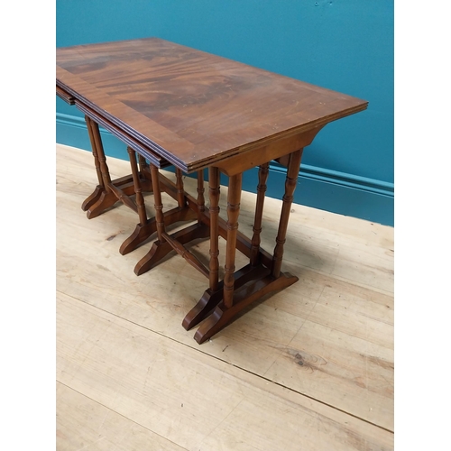 357 - Mahogany nest of three tables raised on turned columns and platform feet {48 cm H x 76 cm W x 41 cm ... 