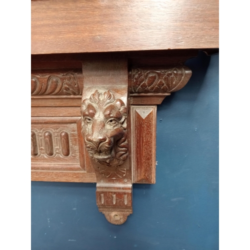 385 - Victorian Oak shelf with hand carved lion corbels {H 50cm x W 142cm x D 21cm }.