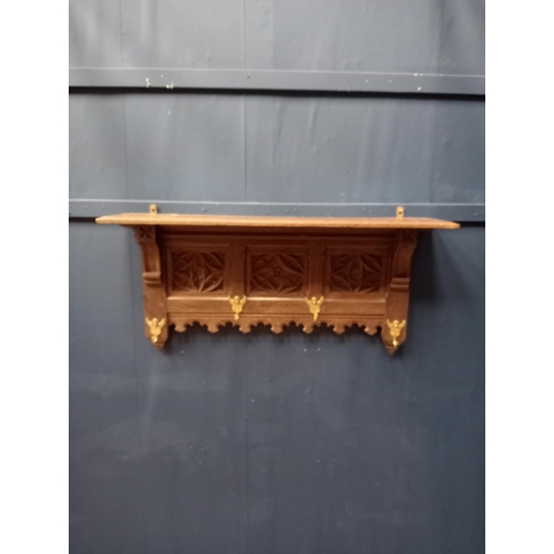 398 - Ornate carved oak coat rack with cherub brass hooks. {H 45cm x W 94cm x D 20cm }.