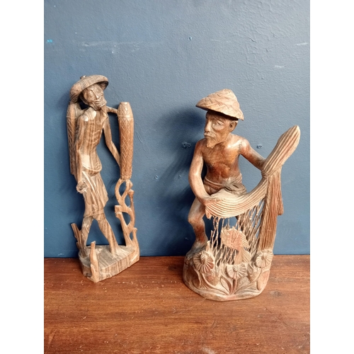 413 - Pair of Balinese hand carved  wooden sculptures of fishermen {H 25cm x W 12cm x D 9cm }.