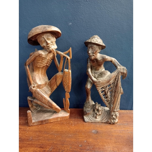 415 - Pair of Balinese hand carved  wooden sculptures of fishermen with net  {Net H 30cm x W 13cm x D 11cm... 