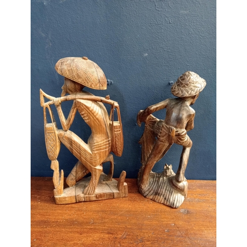 415 - Pair of Balinese hand carved  wooden sculptures of fishermen with net  {Net H 30cm x W 13cm x D 11cm... 