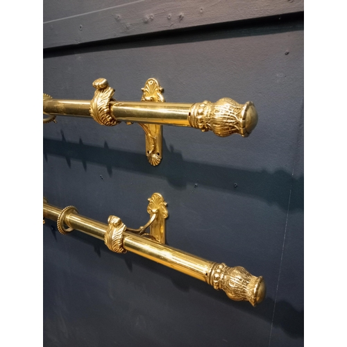 419 - Pair of brass curtain rails with acanthus leaf design {Each H 16cm x W 124cm x D 14cm}.