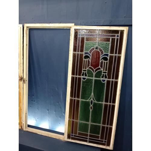 428 - Pair of cast iron leaded stain glass windows with brass handles {Each H 128cm x W 58cm x D 3cm}.