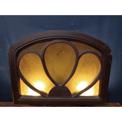 43 - Mahogany arched fanlight with coloured glass insert. {H 66cm x W 84cm x D 19cm}.