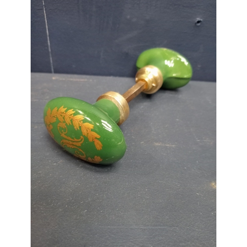 443 - Pair of green oval ceramic and brass door knobs. {H 4cm x W 6cm x D 14cm}.