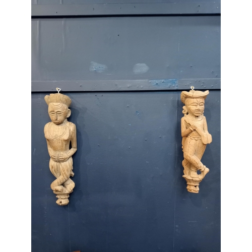 444 - Pair of wooden carved figures. {H 50cm x W 10cm x D 15cm }.