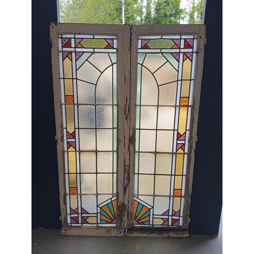 453 - Pair of leaded stain glass windows with brass locks in the Arts and Crafts manner. {Each H 98cm x W ... 