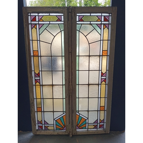 453 - Pair of leaded stain glass windows with brass locks in the Arts and Crafts manner. {Each H 98cm x W ... 