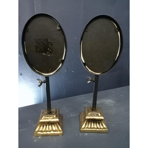 471 - Pair of adjustable oval picture framed pole screens. {H 28cm x W 10cm x D 7cm}.